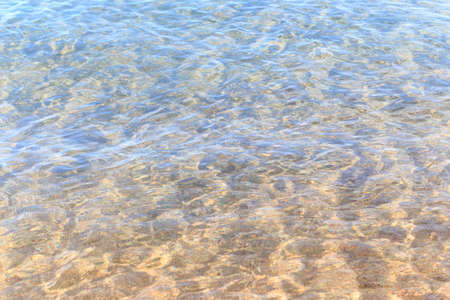 Blue clear water. Sea, lake, sun, beach, vacation Background for inserting images and text. Tourism, travel.の写真素材
