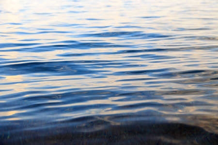 Blue clear water. Sea, lake, sun, beach, vacation Background for inserting images and text. Tourism, travel.の写真素材