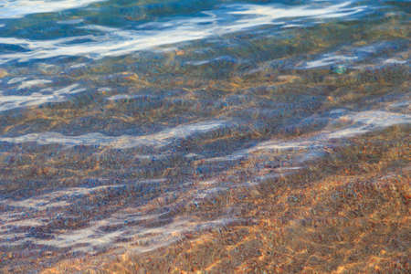 Blue clear water. Sea, lake, sun, beach, vacation Background for inserting images and text. Tourism, travel.の写真素材