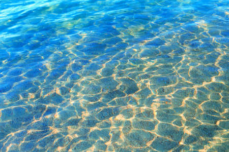 Blue clear water. Sea, lake, sun, beach, vacation Background for inserting images and text. Tourism, travel.の写真素材