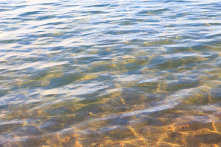 Blue clear water. Sea, lake, sun, beach, vacation Background for inserting images and text. Tourism, travel.の写真素材