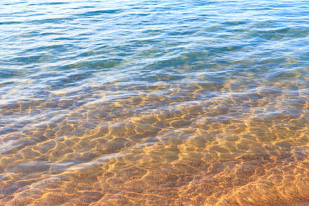 Blue clear water. Sea, lake, sun, beach, vacation Background for inserting images and text. Tourism, travel.の写真素材