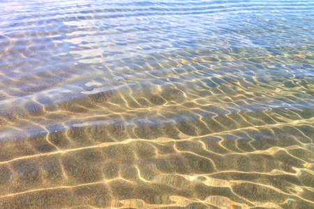 Blue clear water. Sea, lake, sun, beach, vacation Background for inserting images and text. Tourism, travel.の写真素材