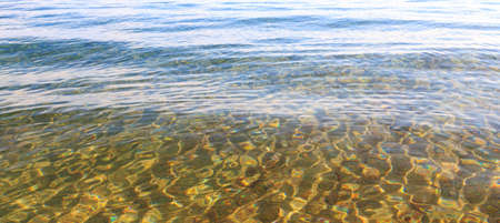 Blue clear water. Sea, lake, sun, beach, vacation Background for inserting images and text. Tourism, travel.の写真素材