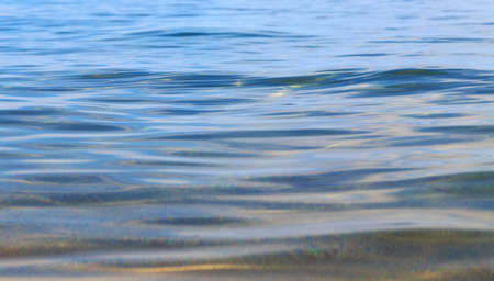 Blue clear water. Sea, lake, sun, beach, vacation Background for inserting images and text. Tourism, travel.の写真素材