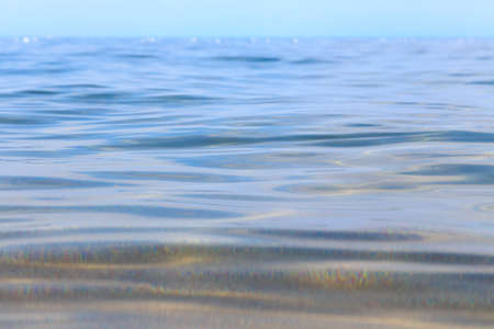 Blue clear water. Sea, lake, sun, beach, vacation Background for inserting images and text. Tourism, travel.の写真素材