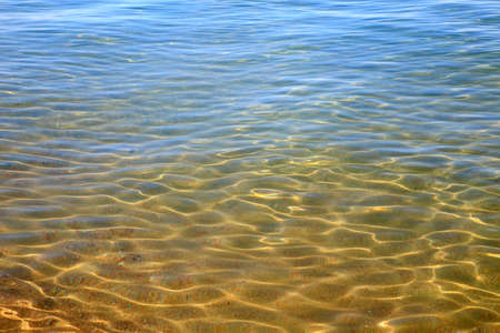Blue clear water. Sea, lake, sun, beach, vacation Background for inserting images and text. Tourism, travel.の写真素材