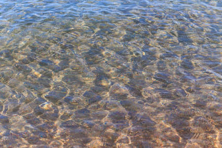 Blue clear water. Sea, lake, sun, beach, vacation Background for inserting images and text. Tourism, travel.の写真素材