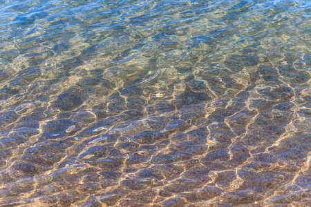 Blue clear water. Sea, lake, sun, beach, vacation Background for inserting images and text. Tourism, travel.の写真素材