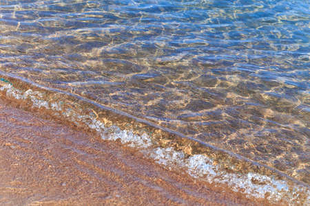 Blue clear water. Sea, lake, sun, beach, vacation Background for inserting images and text. Tourism, travel concept.の写真素材