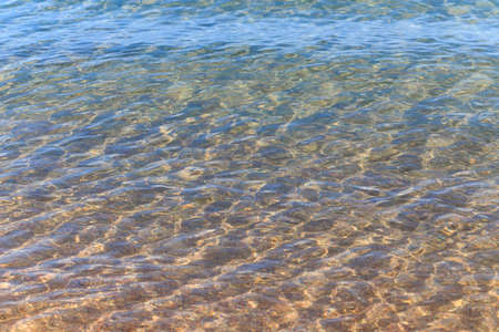 Blue clear water. Sea, lake, sun, beach, vacation Background for inserting images and text. Tourism, travel.の写真素材