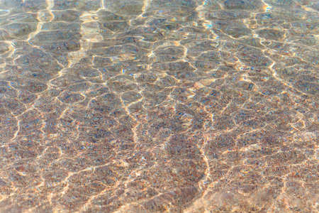 Blue clear water. Sea, lake, sun, beach, vacation Background for inserting images and text. Tourism, travel.の写真素材