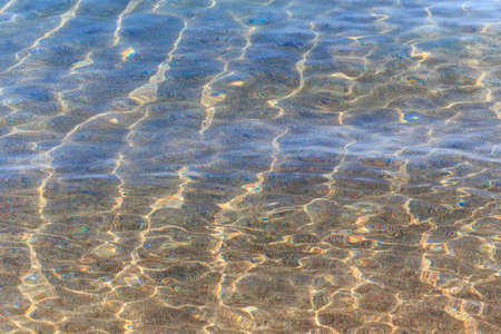 Blue clear water. Sea, lake, sun, beach, vacation Background for inserting images and text. Tourism, travel.の写真素材