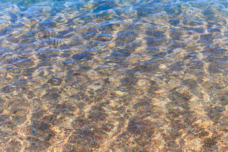 Blue clear water. Sea, lake, sun, beach, vacation Background for inserting images and text. Tourism, travel.の写真素材
