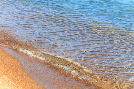 Blue clear water. Sea, lake, sun, beach, vacation Background for inserting images and text. Tourism, travel.の写真素材