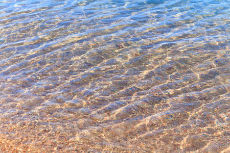 Blue clear water. Sea, lake, sun, beach, vacation Background for inserting images and text. Tourism, travel.の写真素材