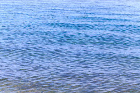 Blue clear water. Sea, lake, sun, beach, vacation Background for inserting images and text. Tourism, travel.の写真素材