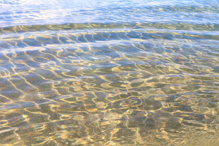 Blue clear water. Sea, lake, sun, beach, vacation Background for inserting images and text. Tourism, travel.の写真素材