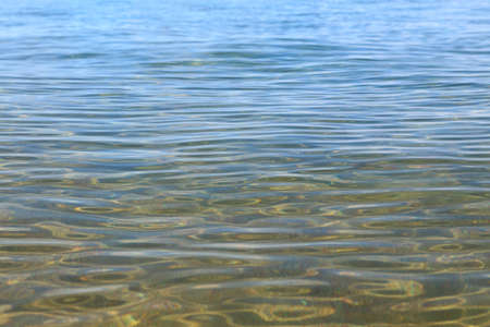 Blue clear water. Sea, lake, sun, beach, vacation Background for inserting images and text. Tourism, travel.の写真素材