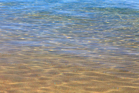 Blue clear water. Sea, lake, sun, beach, vacation Background for inserting images and text. Tourism, travel.の写真素材