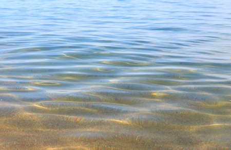 Blue clear water. Sea, lake, sun, beach, vacation Background for inserting images and text. Tourism, travel.の写真素材