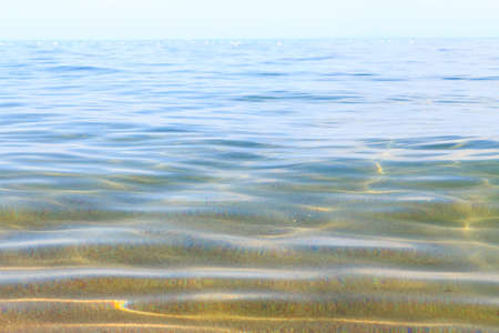 Blue clear water. Sea, lake, sun, beach, vacation Background for inserting images and text. Tourism, travel.の写真素材