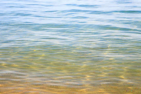 Blue clear water. Sea, lake, sun, beach, vacation Background for inserting images and text. Tourism, travel.の写真素材