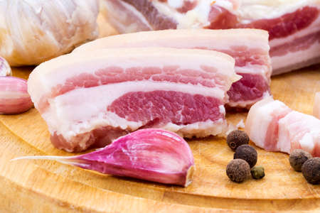 National Russian and Ukrainian food is salo. Sliced bacon on a wooden board. On a white background.の写真素材