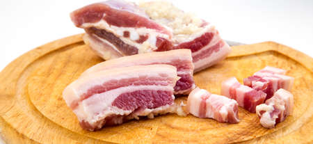 National Russian and Ukrainian food is salo. Sliced bacon on a wooden board. On a white background.の写真素材
