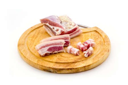 National Russian and Ukrainian food is salo. Sliced bacon on a wooden board. On a white background.の写真素材