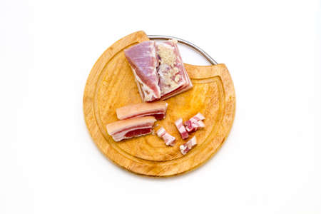 National Russian and Ukrainian food is salo. Sliced bacon on a wooden board. On a white background.の写真素材