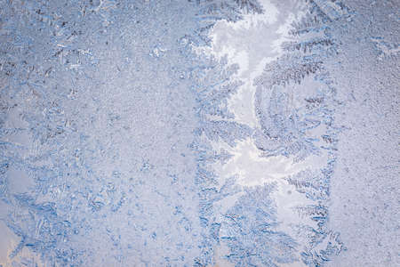 Winter ice pattern on the frozen window. Texture, background for inserting text. New Year theme. Winter. Cold.の写真素材