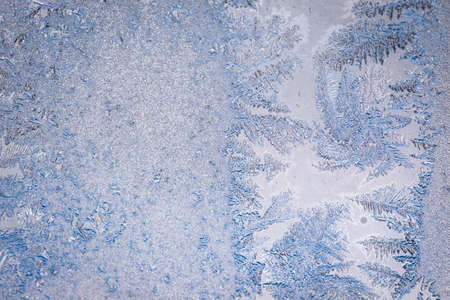 Winter ice pattern on the frozen window. Texture, background for inserting text. New Year theme. Winter. Cold.の写真素材