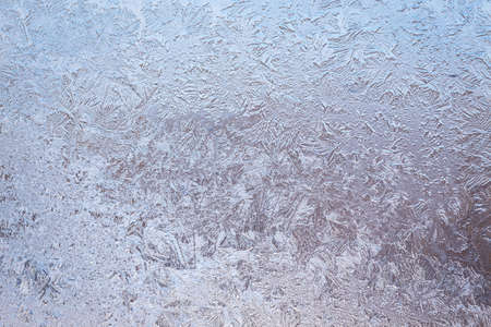 Winter ice pattern on the frozen window. Texture, background for inserting text. New Year theme. Winter. Cold.の写真素材