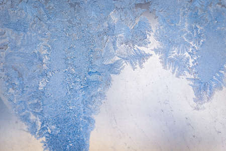 Winter ice pattern on the frozen window. Texture, background for inserting text. New Year theme. Winter. Cold.の写真素材