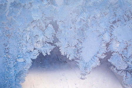 Winter ice pattern on the frozen window. Texture, background for inserting text. New Year theme. Winter. Cold.の写真素材