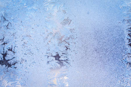 Winter ice pattern on the frozen window. Texture, background for inserting text. New Year theme. Winter. Cold.の写真素材