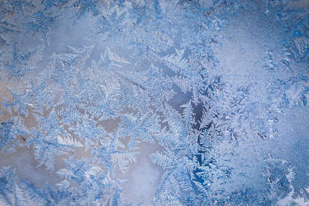 Winter ice pattern on the frozen window. Texture, background for inserting text. New Year theme....