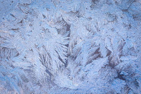 Winter ice pattern on the frozen window. Texture, background for inserting text. New Year theme. Winter. Cold.の写真素材