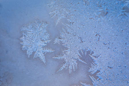 Winter ice pattern on the frozen window. Texture, background for inserting text. New Year theme. Winter. Cold.の写真素材