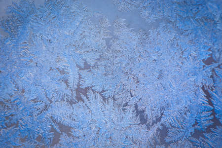 Winter ice pattern on the frozen window. Texture, background for inserting text. New Year theme. Winter. Cold.の写真素材