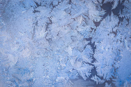 Winter ice pattern on the frozen window. Texture, background for inserting text. New Year theme. Winter. Cold.の写真素材