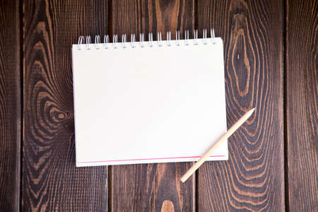 notebook on a wood background. Layout for inserting text and imageの写真素材