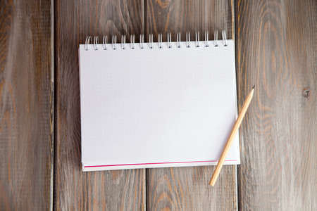 notebook on a wood background. Layout for inserting text and imageの写真素材