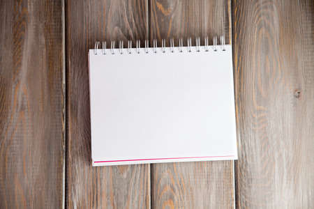 notebook on a wood background. Layout for inserting text and imageの写真素材