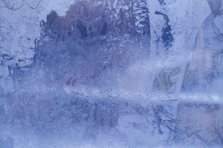 Winter ice pattern on the frozen window. Texture, background for inserting text. New Year theme. Winter. Cold.の写真素材