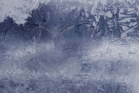 Winter ice pattern on the frozen window. Texture, background for inserting text. New Year theme. Winter. Cold.の写真素材