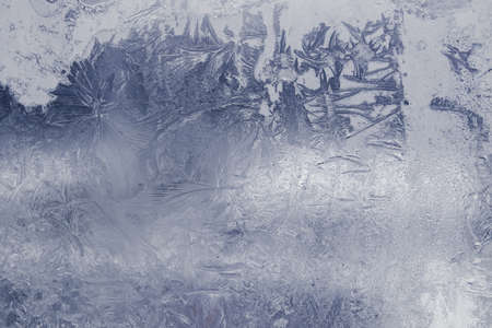 Winter ice pattern on the frozen window. Texture, background for inserting text. New Year theme. Winter. Cold.の写真素材
