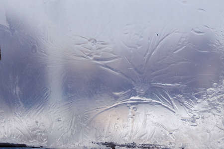 Winter ice pattern on the frozen window. Texture, background for inserting text. New Year theme. Winter. Cold.の写真素材