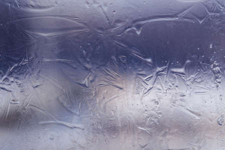 Winter ice pattern on the frozen window. Texture, background for inserting text. New Year theme....